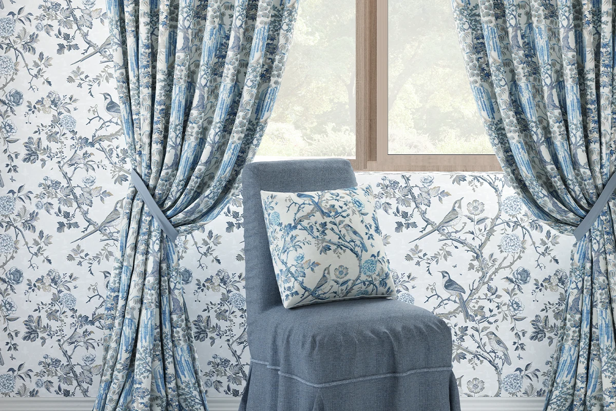 Blue floral wallpaper and drapery with bird cushion look